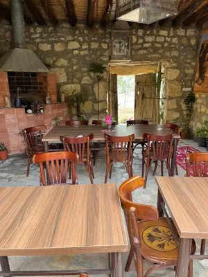 a dining room with wooden tables and chairs at Hartna zaman in Taiyiba