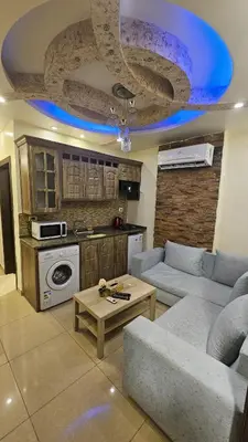 a living room with a couch and a table at Al Tamimi Furnished Apartments in Amman
