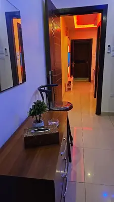 a room with a table and a chair and a hallway at Al Tamimi Furnished Apartments in Amman