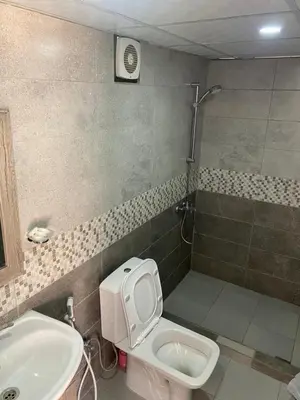 a bathroom with a toilet and a sink at Al Jawhara Luxury Camp in Wadi Rum