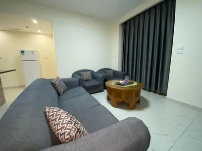 a living room with a couch and a coffee table at سهول الكرمل للأجنحة والشقق الفندقية in Amman