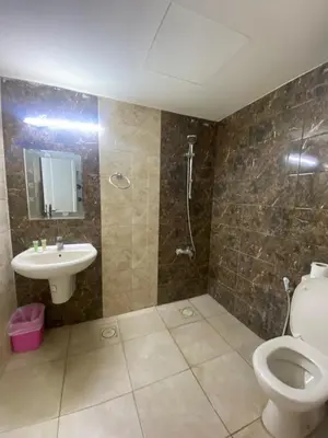 a bathroom with a toilet and a sink and a shower at سهول الكرمل للأجنحة والشقق الفندقية in Amman
