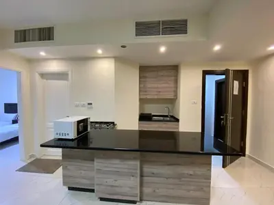 a kitchen with a counter with a microwave on it at سهول الكرمل للأجنحة والشقق الفندقية in Amman