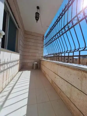 a balcony of a building with a large window at sliver apartment in Bayt Raʼs
