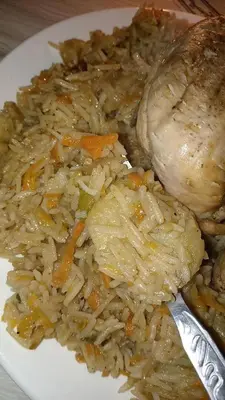 a plate of food with rice and chicken and vegetables at rafat house in Amman
