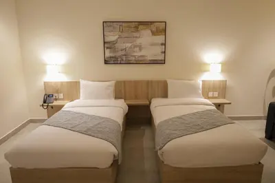 two beds sitting next to each other in a room at ISHQ Hotel in Aqaba