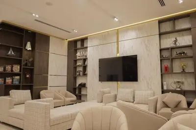 a living room with white furniture and a flat screen tv at ISHQ Hotel in Aqaba