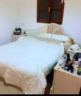 a hospital room with a bed and a desk at too house in Al Mughayyir