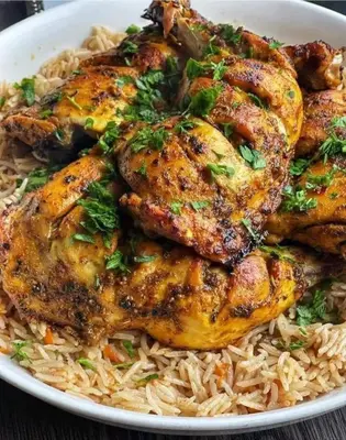 a plate of food with chicken and rice at too house in Al Mughayyir