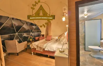 a bedroom with a bed and a chair and a sign at RUM MARS BUBBLE lUXURY CAMP in Wadi Rum