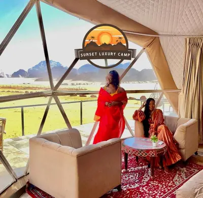 two women sitting in a tent at the sunset unity camp at RUM SUNSET BUBBLES lUXURY CAMP in Wadi Rum