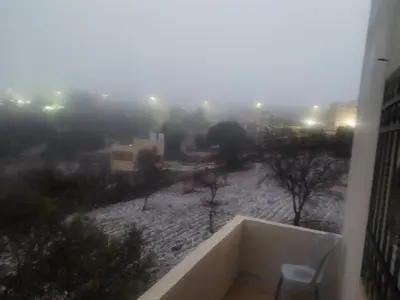 a view of a city in the fog from a building at شقة مفروشة في عجلون رأس منيف in Ajloun