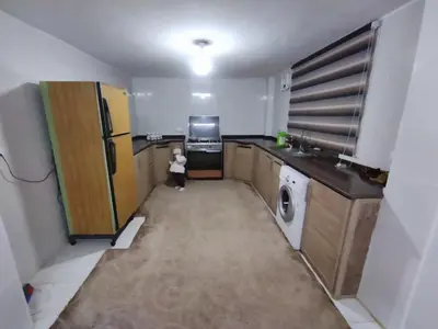a small child is standing in a kitchen at شقة مفروشة في عجلون رأس منيف in Ajloun