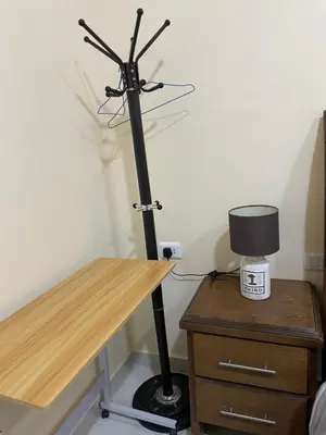 a desk with a microphone and a lamp on a table at Petra 555 Rooms & Apartment in Wadi Musa