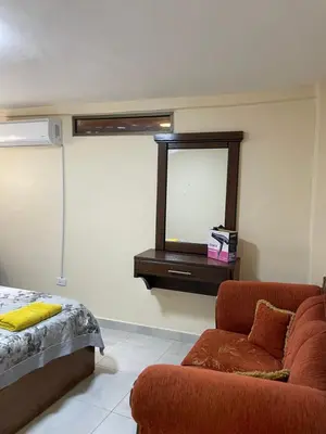 a living room with a couch and a mirror at Petra 555 Rooms & Apartment in Wadi Musa