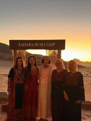 a group of women standing in front of a sign at Zahara rum camp & Boutique Resort in Disah