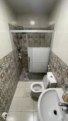 a bathroom with a toilet and a sink at الشاعر للشقق المفروشة in Amman