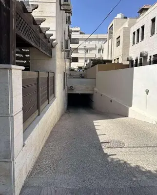 an empty alley way in a city with buildings at الشاعر للشقق المفروشة in Amman