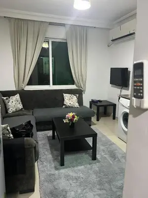 a living room with a couch and a table at الشاعر للشقق المفروشة in Amman