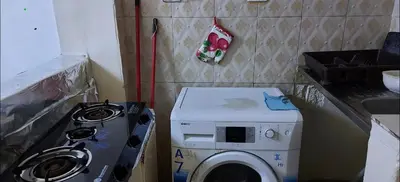a kitchen with a washing machine and a stove at بيت الحجر in Amman