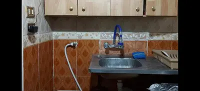 a bathroom with a sink with a hose at بيت الحجر in Amman