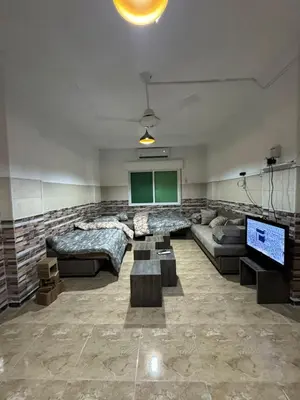 a large living room with a couch and a tv at Decapolis 8 in Irbid
