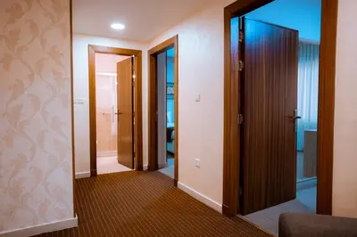a hallway with two doors and a mirror at Rawa Luxury Hotel Suites in Amman