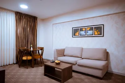 a living room with a couch and a table at Rawa Luxury Hotel Suites in Amman