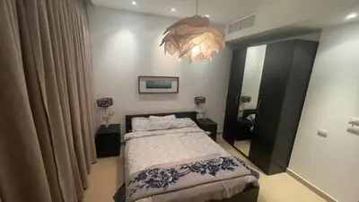 a bedroom with a bed and a large mirror at Luxury home Abdoun complex in Amman