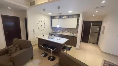 a kitchen and living room with a couch and a table at Luxury home Abdoun complex in Amman