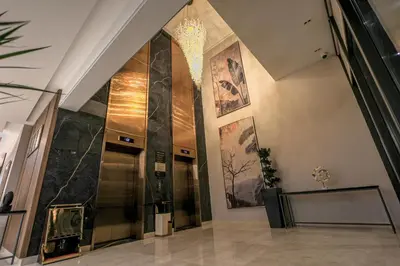 a lobby of a building with a elevator at Swisstouches Hotel Amman in Amman