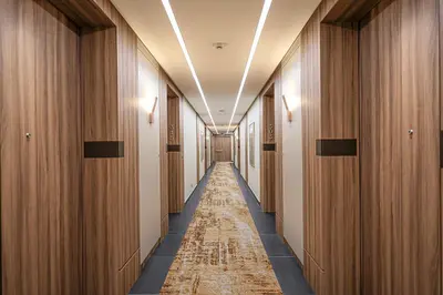 a corridor of a hotel hallway with wooden walls and a long aisle at Swisstouches Hotel Amman in Amman