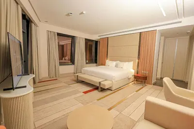 a hotel room with a bed and a television at Swisstouches Hotel Amman in Amman