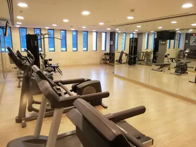a gym with treadmills and ellipticals at DAMAC Pool View Penthouse in Amman