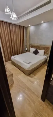 a bedroom with a large bed in a room at unique 2bedroom at abdoun 001 in Amman