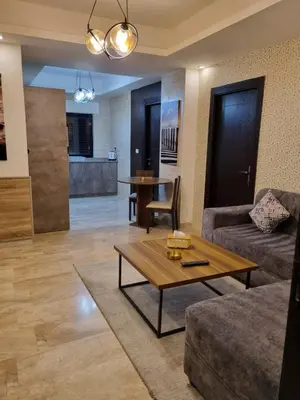 a living room with a couch and a table at unique 2bedroom at abdoun 001 in Amman