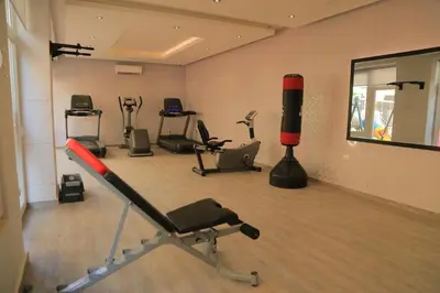 a gym with several exercise equipment in a room at Montana Residence in Amman