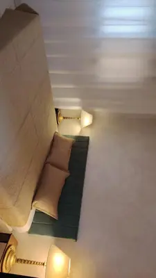 a room with a couch with two pillows on it at Al Wesam Furnished Apartments in Aqaba