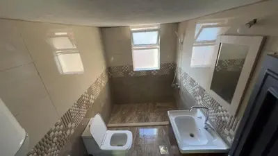 a small bathroom with a sink and a toilet at Art loft in Amman