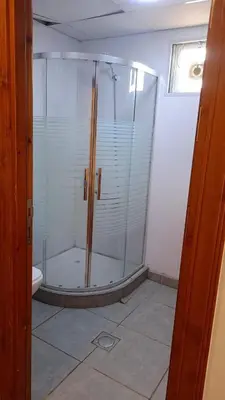 a glass shower in a bathroom with a toilet at Rum Pillars Camp in Disah