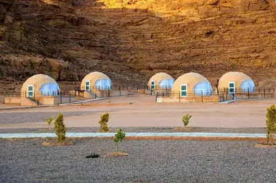 a group of domes in front of a mountain at Rum Pillars Camp in Disah
