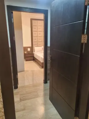 a door leading to a bedroom with a bed at unique 2bedroom at abdoun 006 in Amman