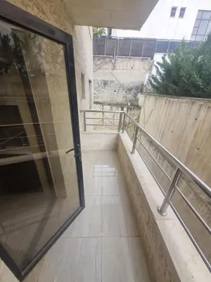 a glass door on the side of a building at unique 2bedroom at abdoun 006 in Amman