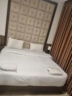 a bedroom with a large bed with a large headboard at unique 2bedroom at abdoun 006 in Amman