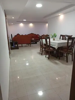 a dining room with a table and chairs and a couch at Misk Home in Amman