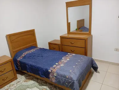 a bedroom with a bed and a mirror at Misk Home in Amman