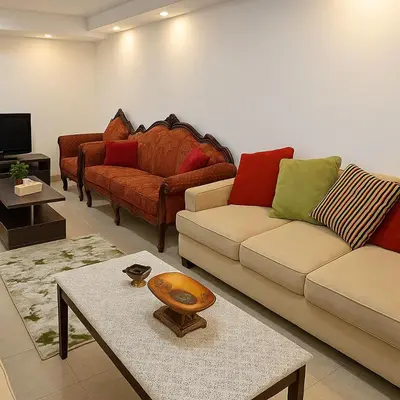 a living room with two couches and a table at Misk Home in Amman