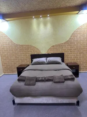 a bedroom with a large bed in a brick wall at WaterMill House in Wadi Musa