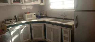 a kitchen with a sink and a microwave at WaterMill House in Wadi Musa