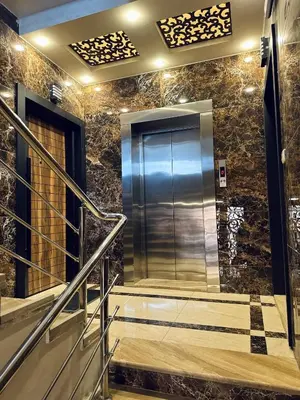 a elevator in a building with stone walls and stairs at Sweet Home In Amman - Family Friendly in Amman
